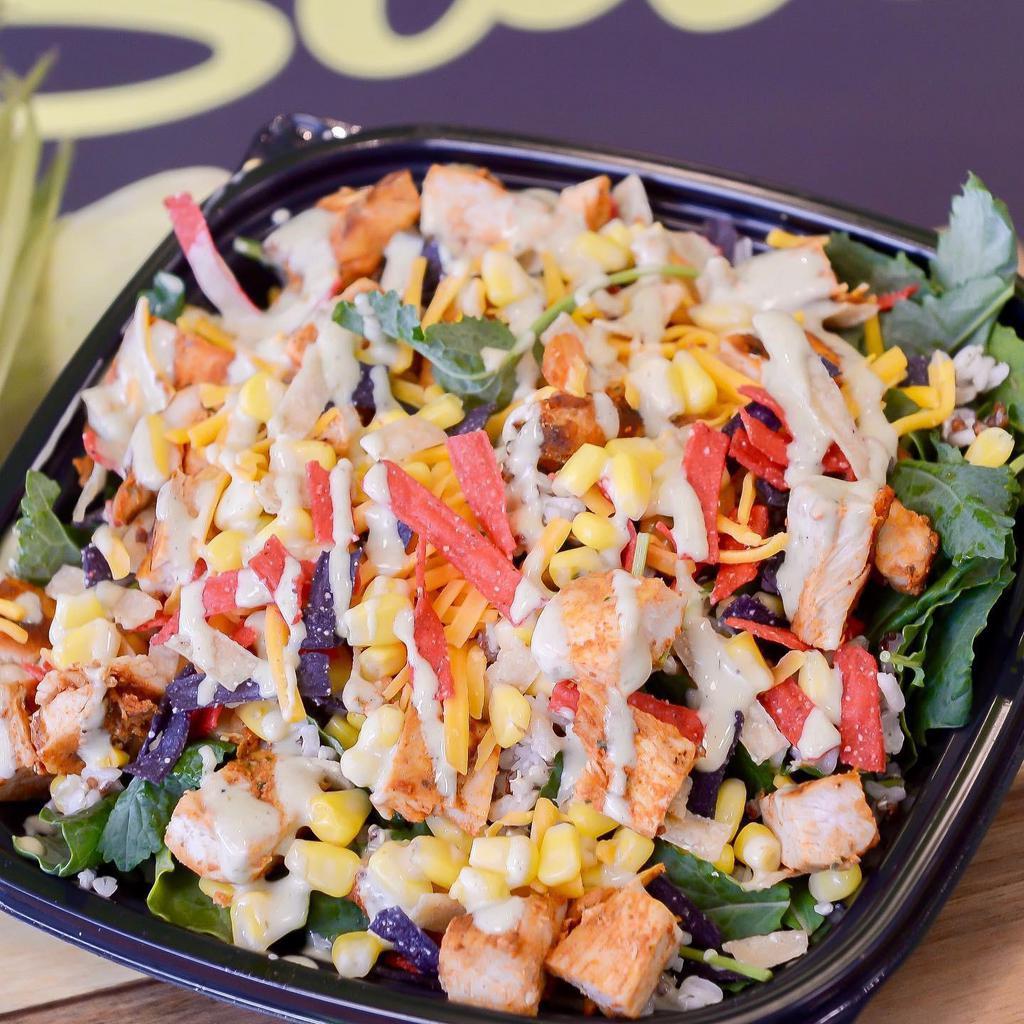 My Spicy Chicken Bowl · Served with baby kale, cajun grilled chicken, cheddar, corn, lime chipotle vinaigrette, organic brown rice quinoa, and tortilla strips.