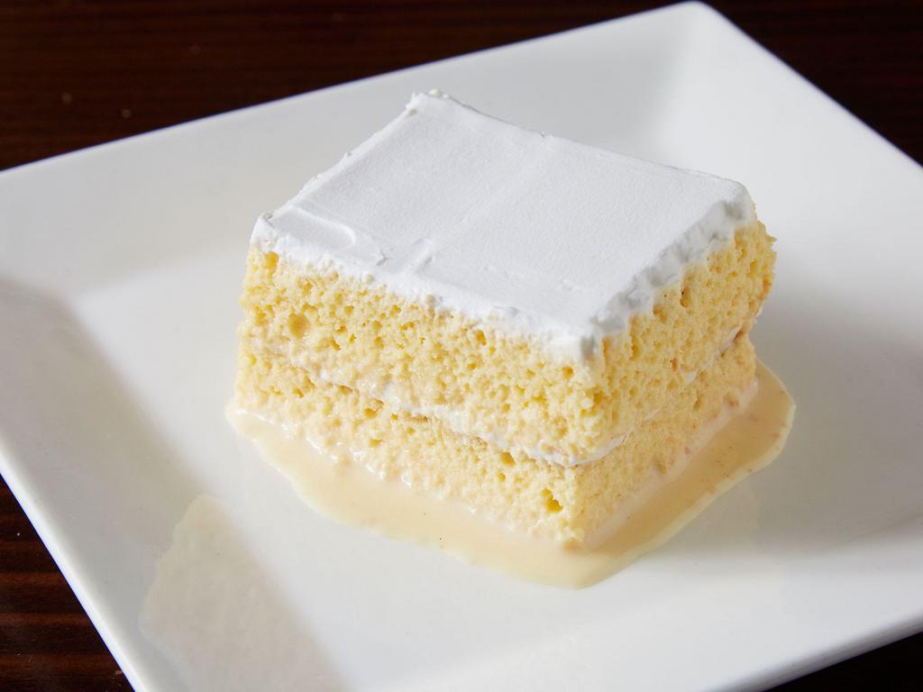 Tres Leches Cake · Sponge cake soaked in three different types of milks accompanied by whipped frosting on top. A popular family favorite in Mexico.
