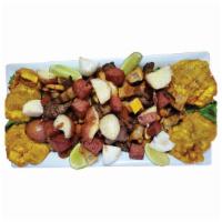 18. Picada Colombiana · Clombian sausages, pork skin, grilled meat, fried green plantain, cassava, corn cake  and po...