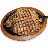 34. Churrasco Asado · Grilled sirloin steak.  It comes with rice, salad and beans or french fries.
