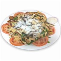 61. Ensalada Cesar · Caesar salad with grilled chicken and dressing.