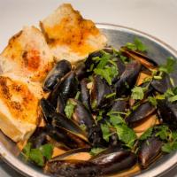Miso Sake Mussels · Mussels sauteed in our sake infused in our creamy Cajun sauce served with our Cajun Toast.