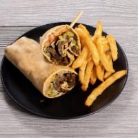 Beef Shawarma Sandwich · Served with tahini sauce, pickles, onions and tomatoes wrapped in pita bread. 