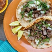 Regular Taco · Choice of filling with onions and cilantro on a soft corn tortilla.