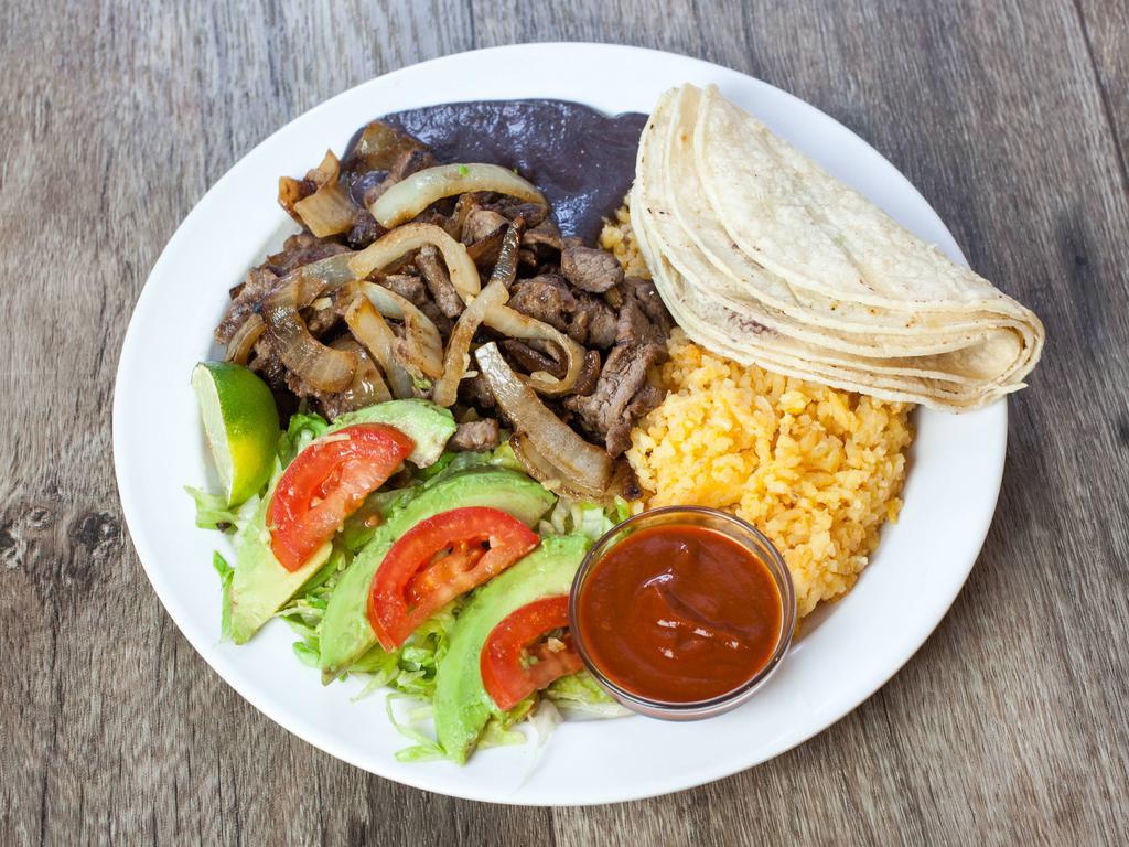 Bistec Encebollado · Onion steak. Served with rice, beans, salad, avocado and tortillas.