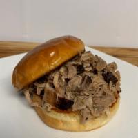 Pulled Pork Sandwich · Slow-cooked pulled pork served on a butter grilled bulkie roll.