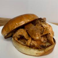 Pulled Chicken Sandwich · Smoked pulled chicken served on a butter grilled bulkie roll.