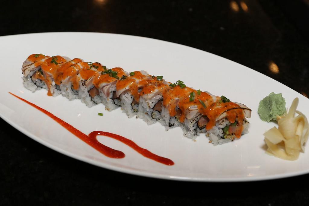 Phoenix Roll · Smoked salmon, jalapeno, tempura flake, topped with seared yellowtail, spicy mayo sauce and scallion.