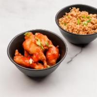 Sweet and Sour Chicken · Deep Fried White Meat Chicken Drizzled with Red Sweet and Sour Sauce.  Served with Fried Ric...