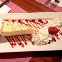 New York Cheesecake · Drizzled with raspberry sauce.