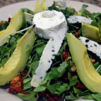 Monte Bianco Salad · Arugula, avocado, sun-dried tomatoes topped with goat cheese and shaved Parmesan.
