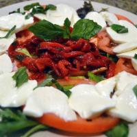 Caprese Salad · Fresh mozzarella and tomato topped with basil and extra virgin olive oil.

