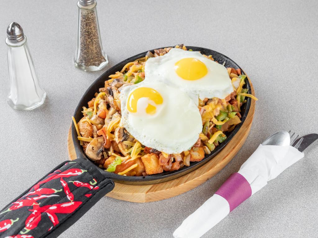 The Everything Skillet · Grilled ham, mushrooms, green peppers, tomatoes, onions, and American cheese with two eggs served over breakfast potatoes