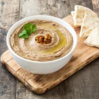 Hummus with Pita · Made from garbanzo beans and cooked till tender, then blended to perfection with tahini, gar...