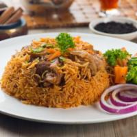 Halal Lamb Over Rice and Salad · Halal lamb with vegetables over a bed of rice.