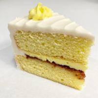 Lemon Raspberry Cake, by the slice! · Layers of lemon cake, filled with a lemon zest buttercream and raspberry preserves.