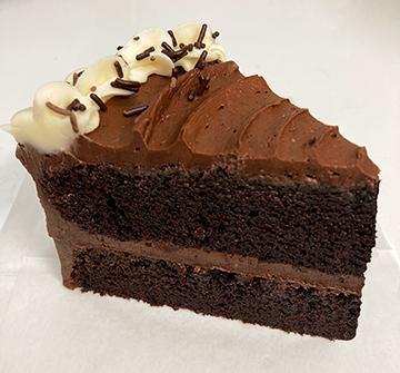 SOLD OUT . . Chocolate Chocolate Cake, by the slice! · By popular request, our rich dark chocolate cake, with chocolate buttercream filling and frosting. Chocolate lovers rejoice!