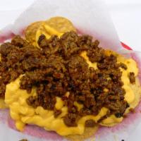 BEEF NACHOS · Round nachos, nacho cheese, chopped beef burger & bbq fusion sauce
