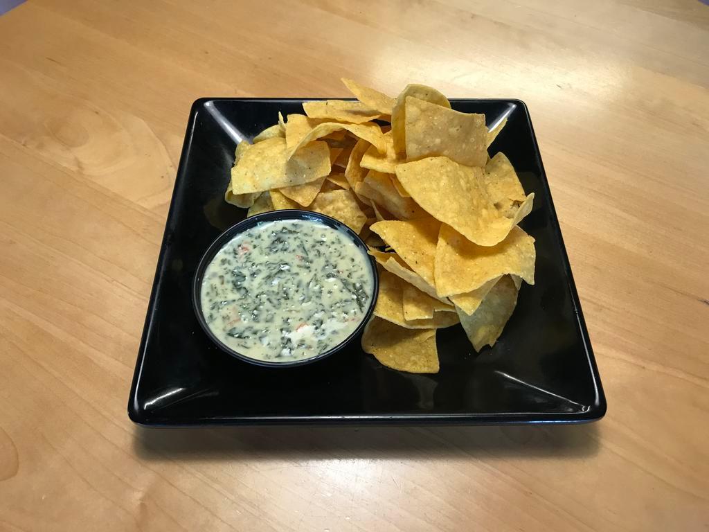 Spinach Artichoke Dip  · Cheesy blend of chopped spinach and artichoke hearts, cream cheese, and diced tomatoes. With fresh made tortilla chips.
