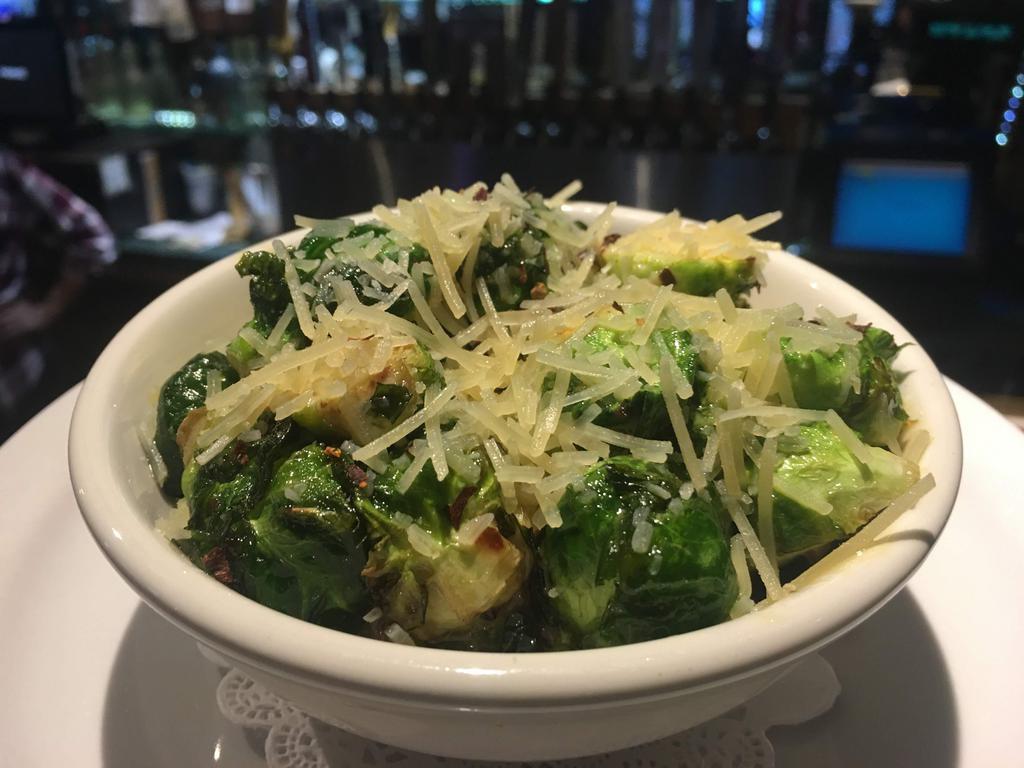 Fried Brussels Sprouts · Fried brussels sprouts tossed with olive oil, balsamic vinaigrette, honey mustard and crushed red peppers. Topped with Parmesan cheese.