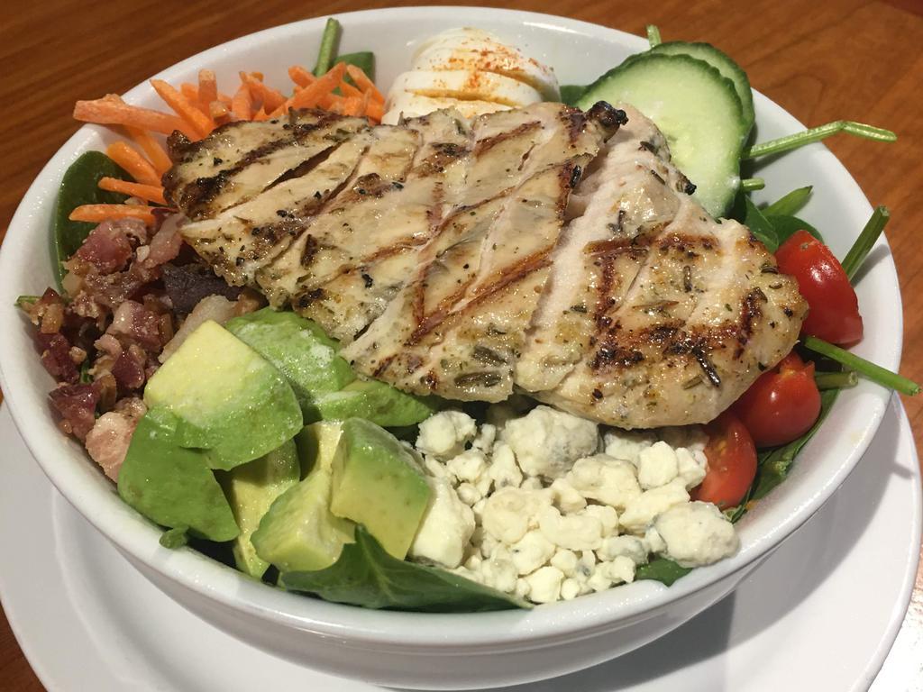 Spinach Cobb Salad · smoked chicken, bacon, carrots, cucumbers, avocado, hard boiled egg, grape tomatoes and blue cheese crumbles.