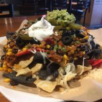 Deluxe Nachos · Choice of ground beef , shredded chicken or pulled pork. Topped with pico de gallo, jalapeno...