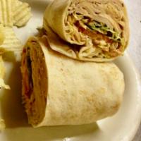 Turkey Wrap · sliced deli turkey, russian dressing, lettuce, tomatoes and side of chips.