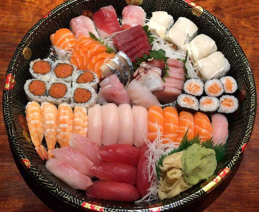 C. Sushi & Sashimi Platter · Sushi includes 4 pieces tuna, 4 pieces yellowtail, 4 pieces salmon, 4 pieces shrimp and 4 pieces white fish. Sashimi includes 6 pieces tuna, 6 pieces salmon, 6 pieces yellowtail, 6 pieces white fish, 3 pieces mackerel and 3 pieces white tuna . Rolls include 1 spicy tuna toll, 1 salmon roll, 1 rainbow roll and 1 tsunami roll.