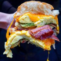 Penny Egg Sandwich · Scrambled eggs, cheddar, bacon and avocado on a brioche bun.