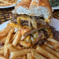 Philly Cheese Steak Sandwich · Hot roast beef, fried onions and American cheese on hero with french fries.