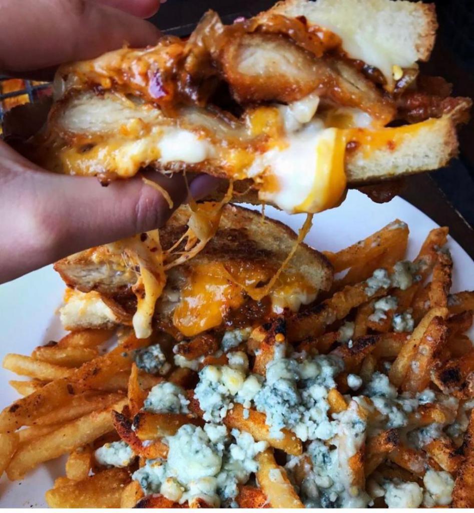 The Dre Stuffed Grilled Cheese · Breaded chicken cutlet, mozzarella and cheddar, caramelized onions, roasted garlic, spicy mayo, country white bread and Gorgonzola Cajun french fries.