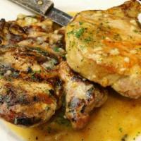 Sauteed Garlic Pork Chops · Served with potato and vegetables.