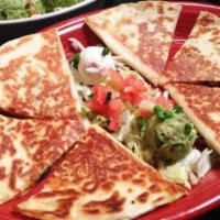 Quesadillas · 2 large flour tortillas stuffed with cheddar cheese and a tasty blend of poblano chilies, ha...