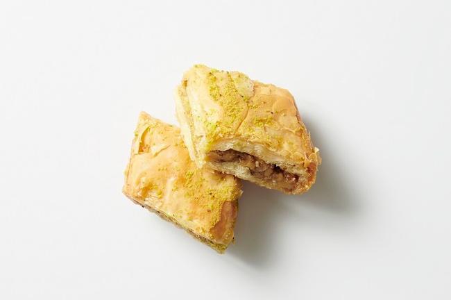 - Baklava · Layers of phyllo filled with chopped walnuts & cinnamon, drizzled with syrup & honey. (one piece)