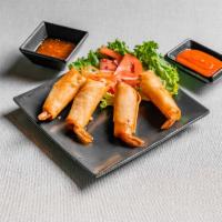 A4. Rocket Shrimps · 4 crispy jumbo shrimp and onion wrapped in spring roll shell served with fish sauce.