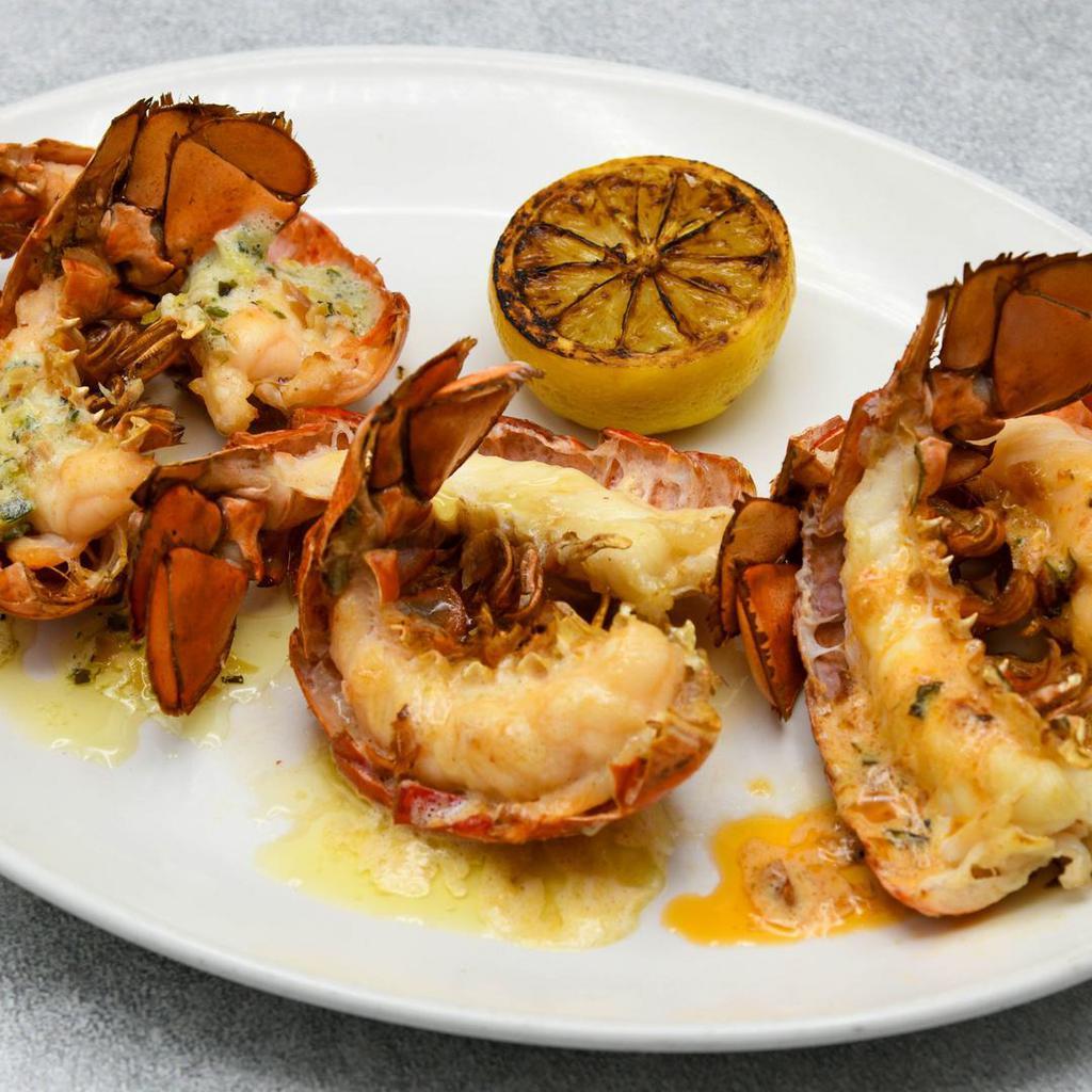 Petite Lobster Tail Trio · 3 Petite Cold Water Lobster Tails Broiled, Sriracha Tomato Butter, Almond Herb Butter, Uni Butter, Grilled Lemon