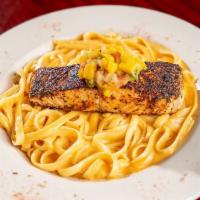Fire-Grilled Atlantic Salmon · Topped with a mango habanero salsa. Served over linguine pasta.