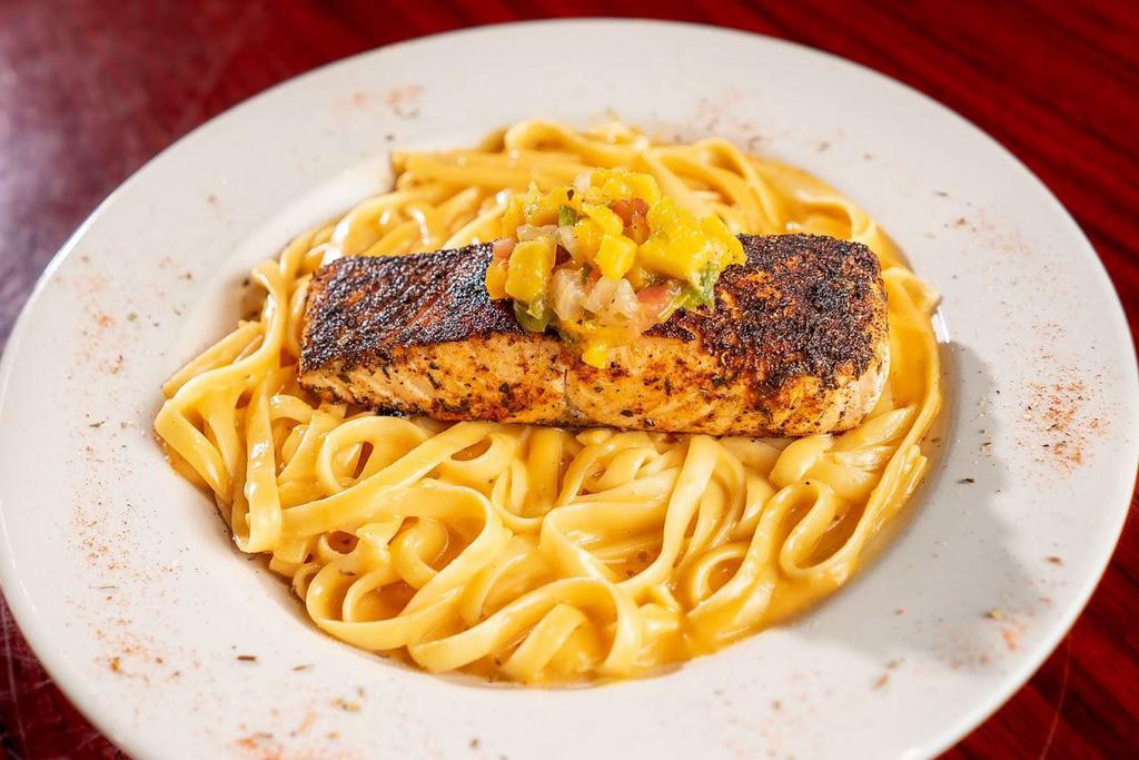 Fire-Grilled Atlantic Salmon · Topped with a mango habanero salsa. Served over linguine pasta.