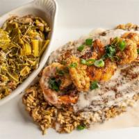 Bayou Catfish · Crispy blackened catfish topped with shrimp, oysters, and Cajun butter sauce. Served over a ...