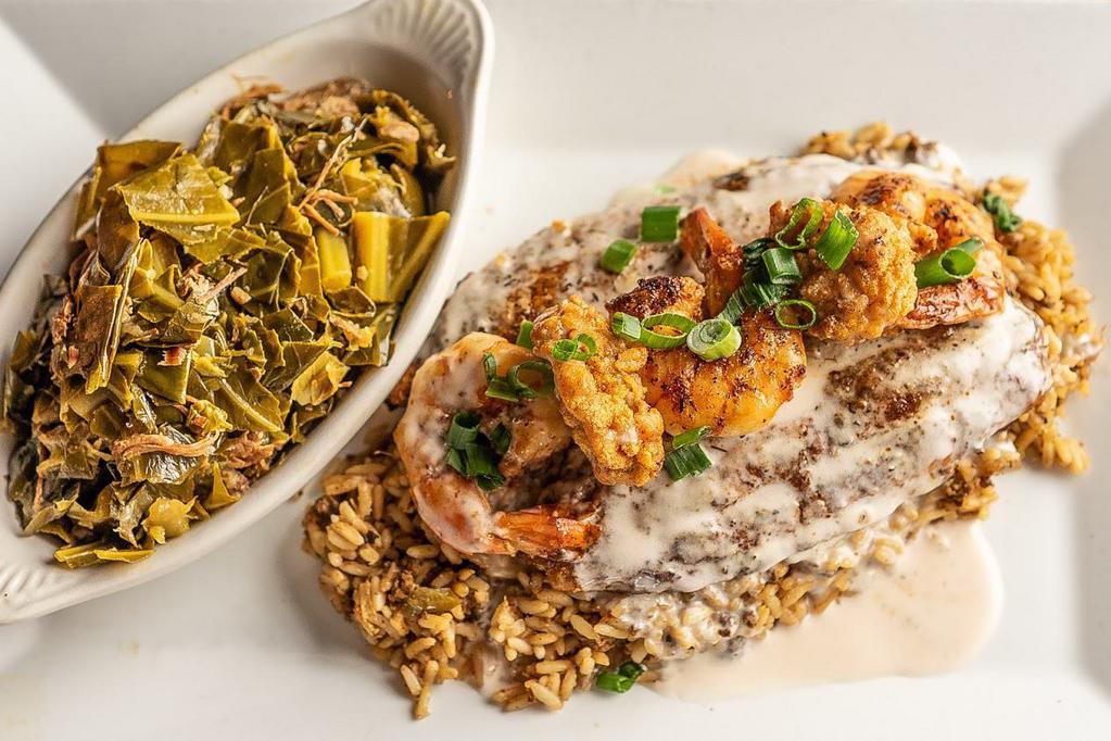 Bayou Catfish · Crispy blackened catfish topped with shrimp, oysters, and Cajun butter sauce. Served over a bed of dirty rice with
collard greens.
