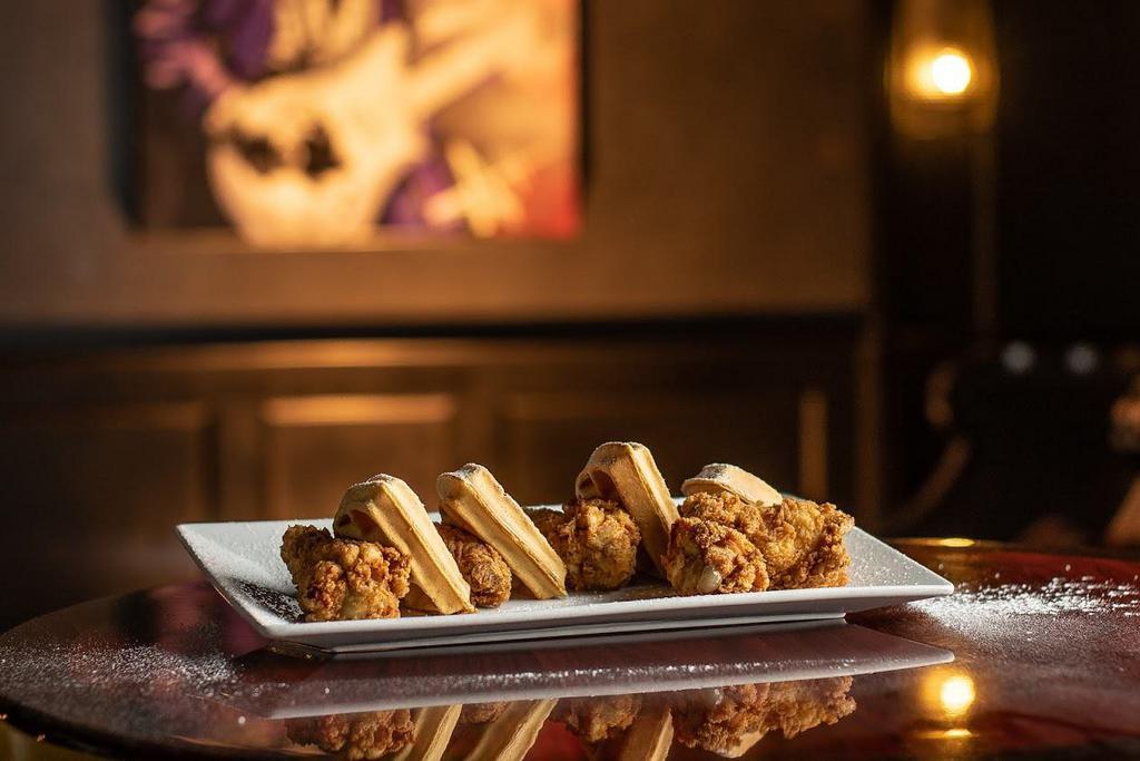 Chicken and Waffles · Crispy buttermilk-battered chicken wings, fresh-baked waffles, and a Bourbon Foster sauce.
