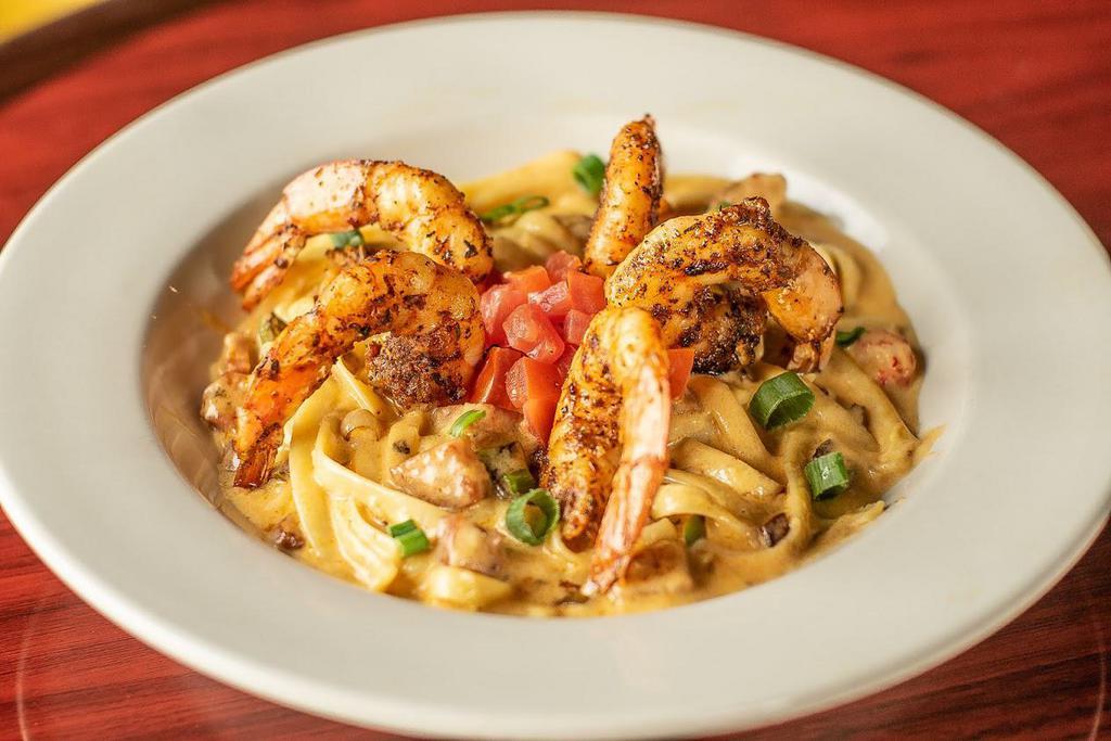 Seafood Pasta · Blackened shrimp, crawfish tails, and andouille sausage in a white wine cream sauce. Served over linguini.