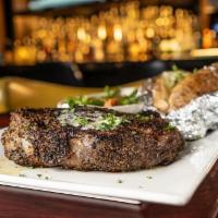 Crescent City Ribeye · Marinated center cut 12 oz. Angus ribeye, charbroiled to order. Served with garlic-Parmesan ...
