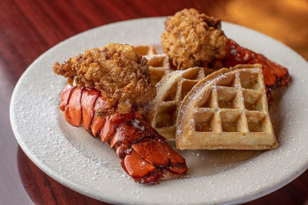 Lobster & Waffles · Two seasoned lobster tails (grilled or fried) severed with hot waffles drizzled with icing and cinnamon glaze 