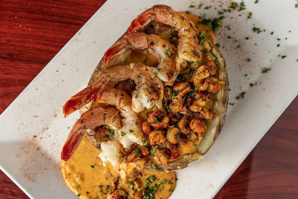 Seafood Fondue Potato · 1lb baked potato stuffed with our house made cheese fondue sauce, blackened chicken, crawfish tails and grilled shrimp.
