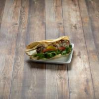 Falafel Sandwich · Our homemade falafel with lettuce, tomatoes, pickles, and tahini sauce wrapped in a pita bre...