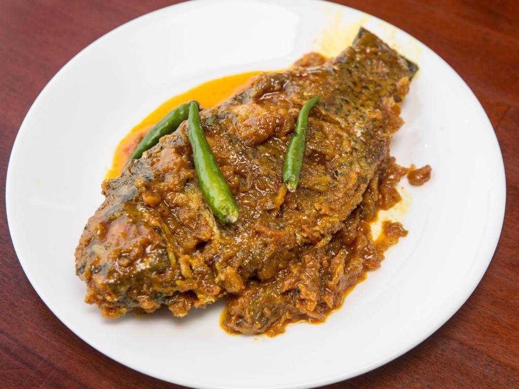 Fish Curry · Chef's choice of Bangladeshi mrigel, katla, ruhu, ayre, boal or koi fish cooked with gravy, fine spices. Served with white rice and salad.
