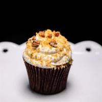 Italian Cream Cupcake · 2 vanilla cake topped with roasted coconut and pecan bits.