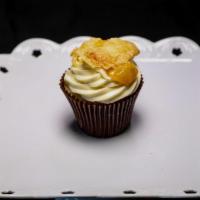 Peach Cobbler Surprise Cupcake · 2 vanilla cake filled and topped with peach cobbler and cream cheese icing.