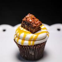 Brownie Funday Cupcake · 1 chocolate cake topped with vanilla buttercream icing brownie bits and caramel drizzle.